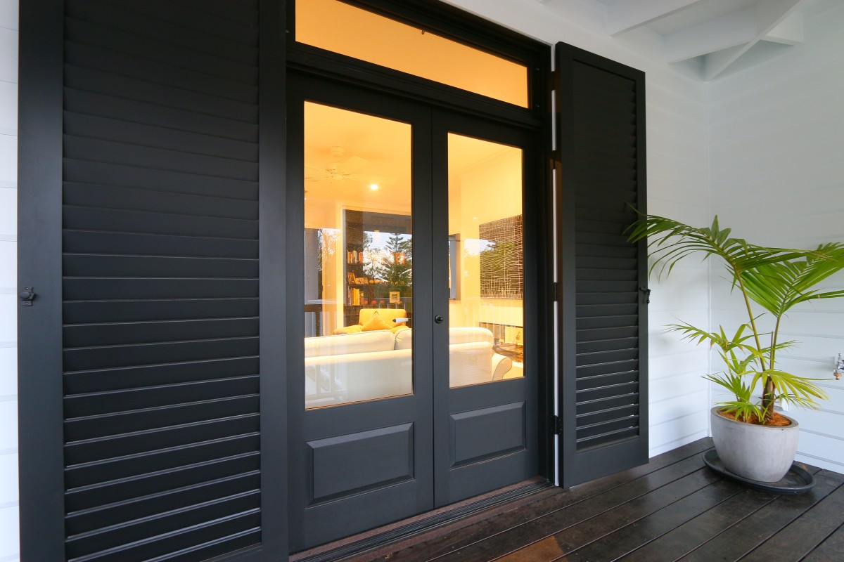 External timber shutters painted black verandah door Cedar West