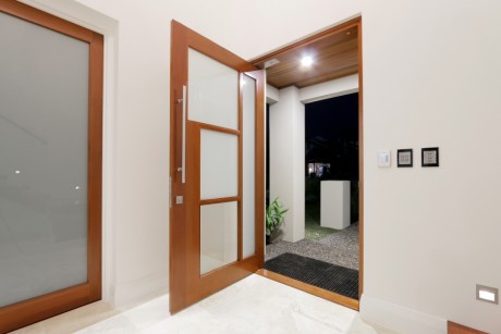Custom pivot door timber shaped glass Cedar West