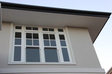 Double hung timber window painted white glazing bars
