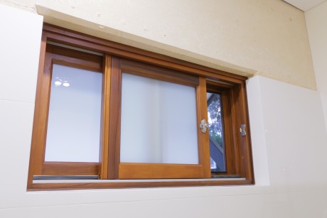 Sliding window partially open solid timber frame Cedar West